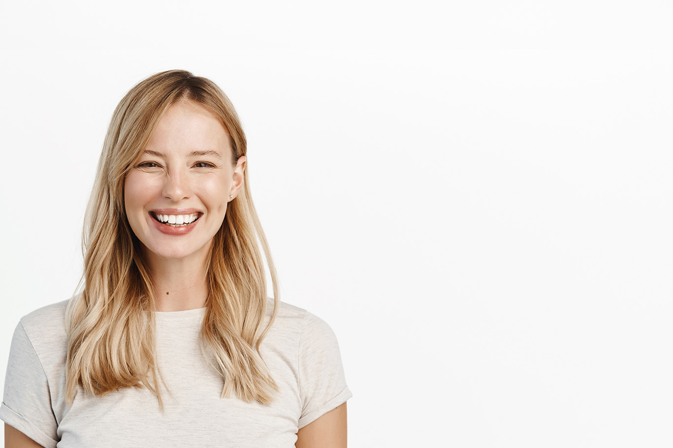 A smiling woman with short hair poses against a white background.